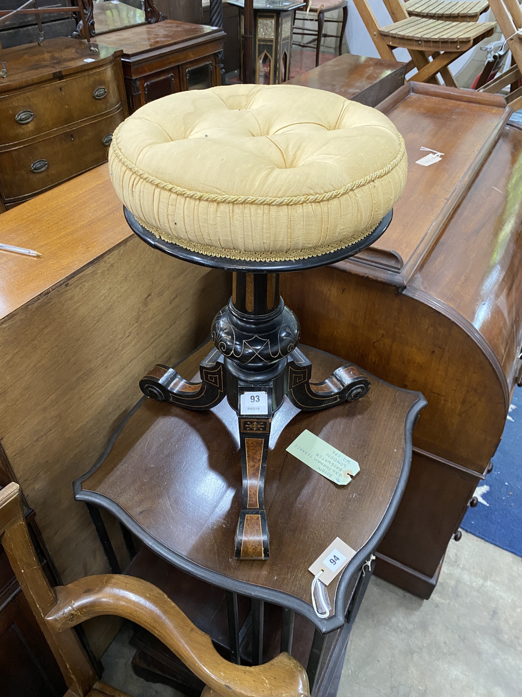 A late Victorian ebonised amboyna revolving adjustable piano stool